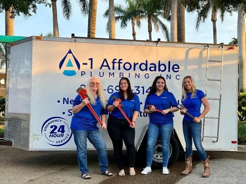 A-1 Affordable Plumbing office ladies holding pipe wrenches